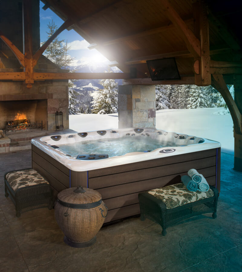 Hot tub retreat with fireplace in a winter setting